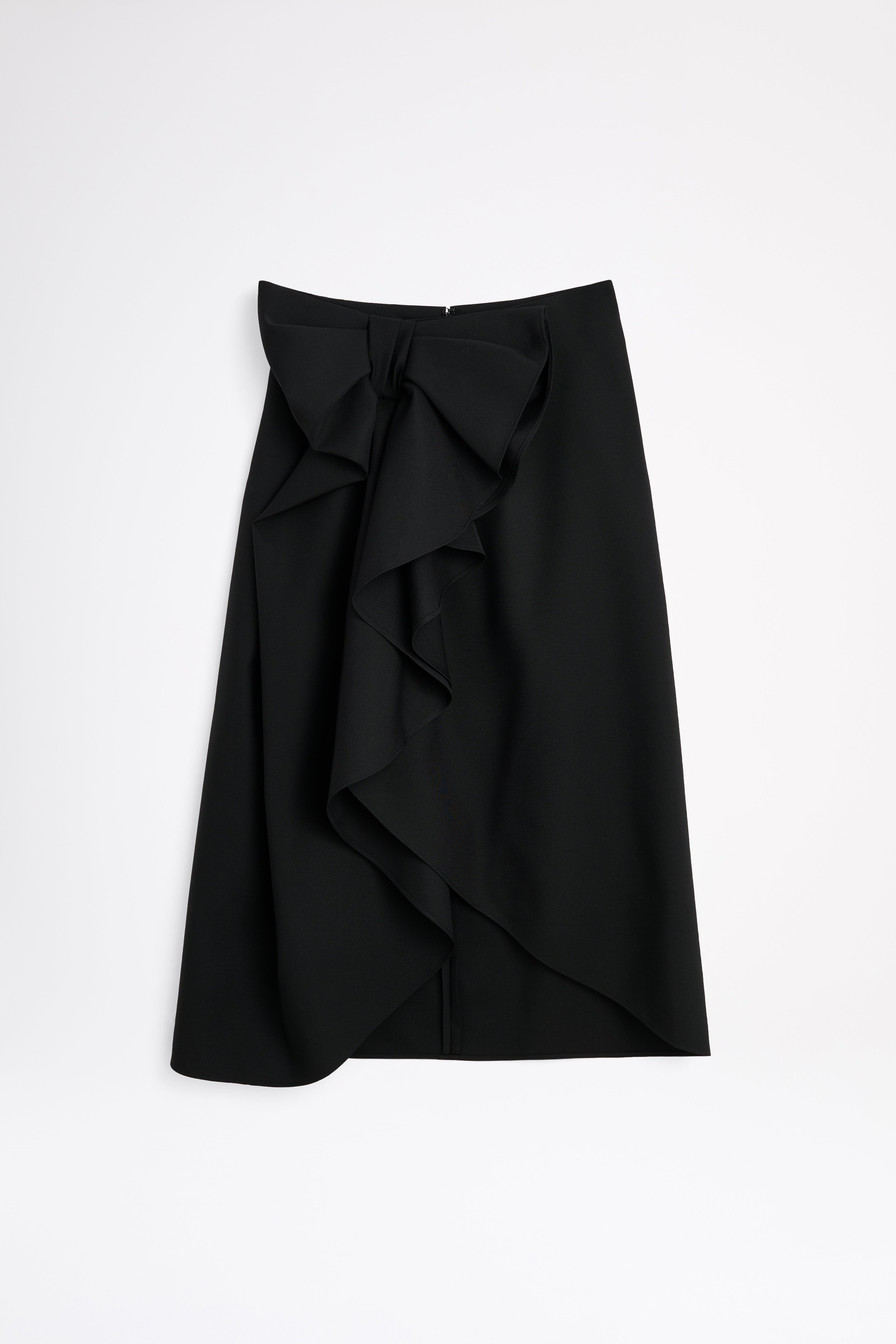 Black wool skirt with a bow on a white background.