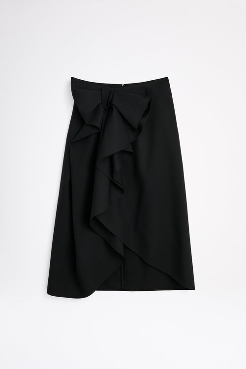 Black wool skirt with a bow on a white background.