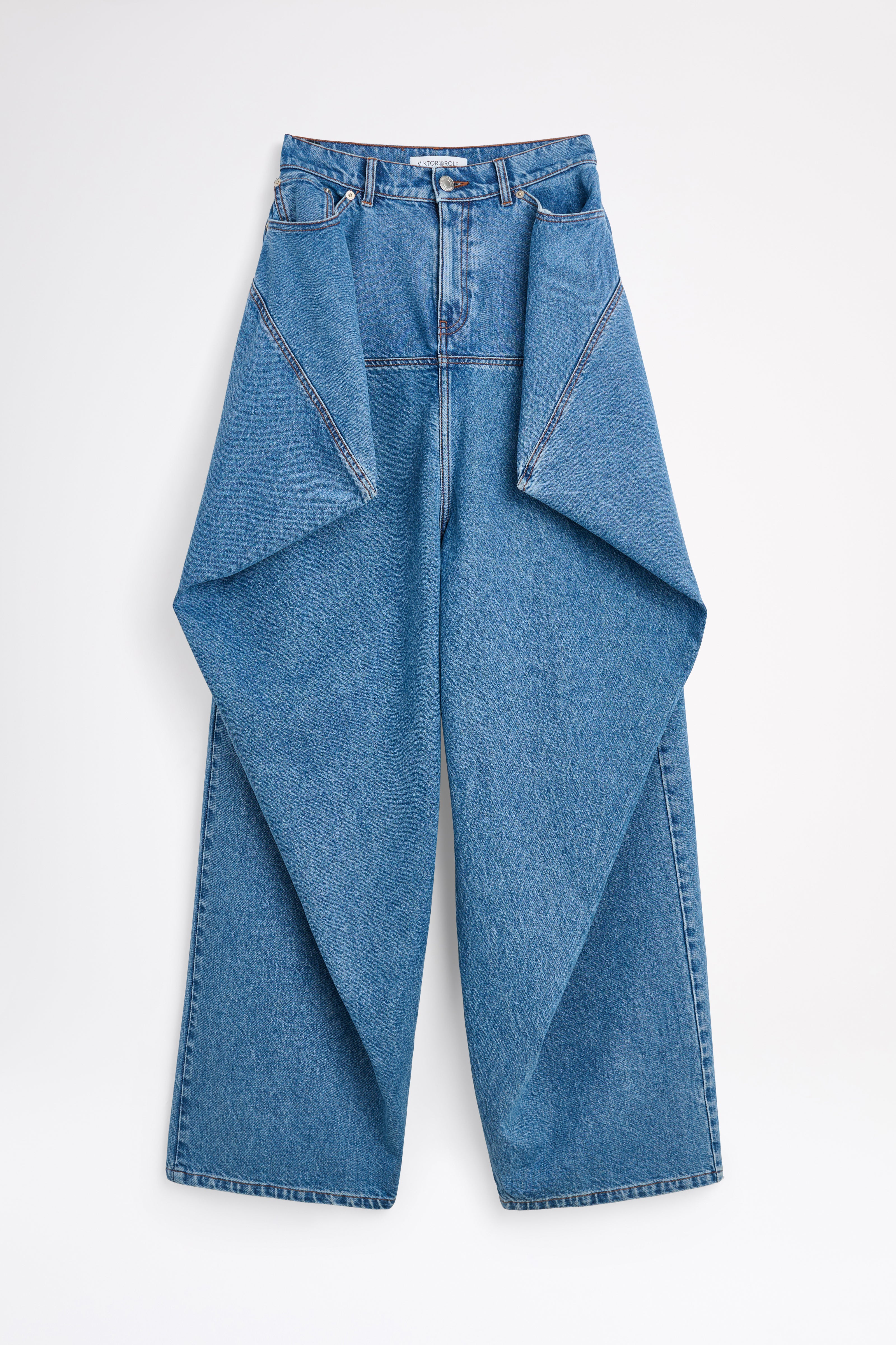 Woman wearing a burgundy top and blue jeans on a white background