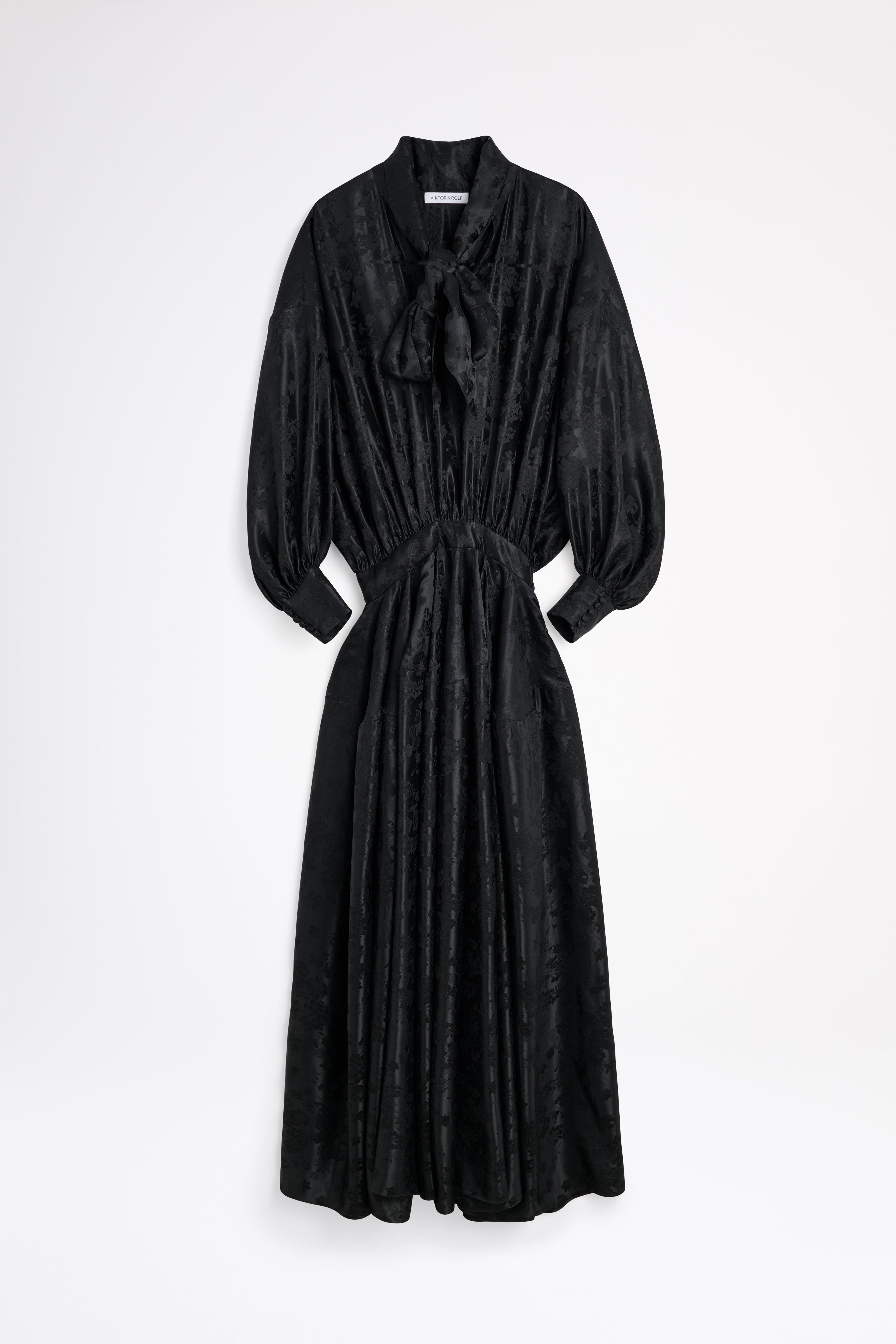 Black dress with a tie neckline on a white background