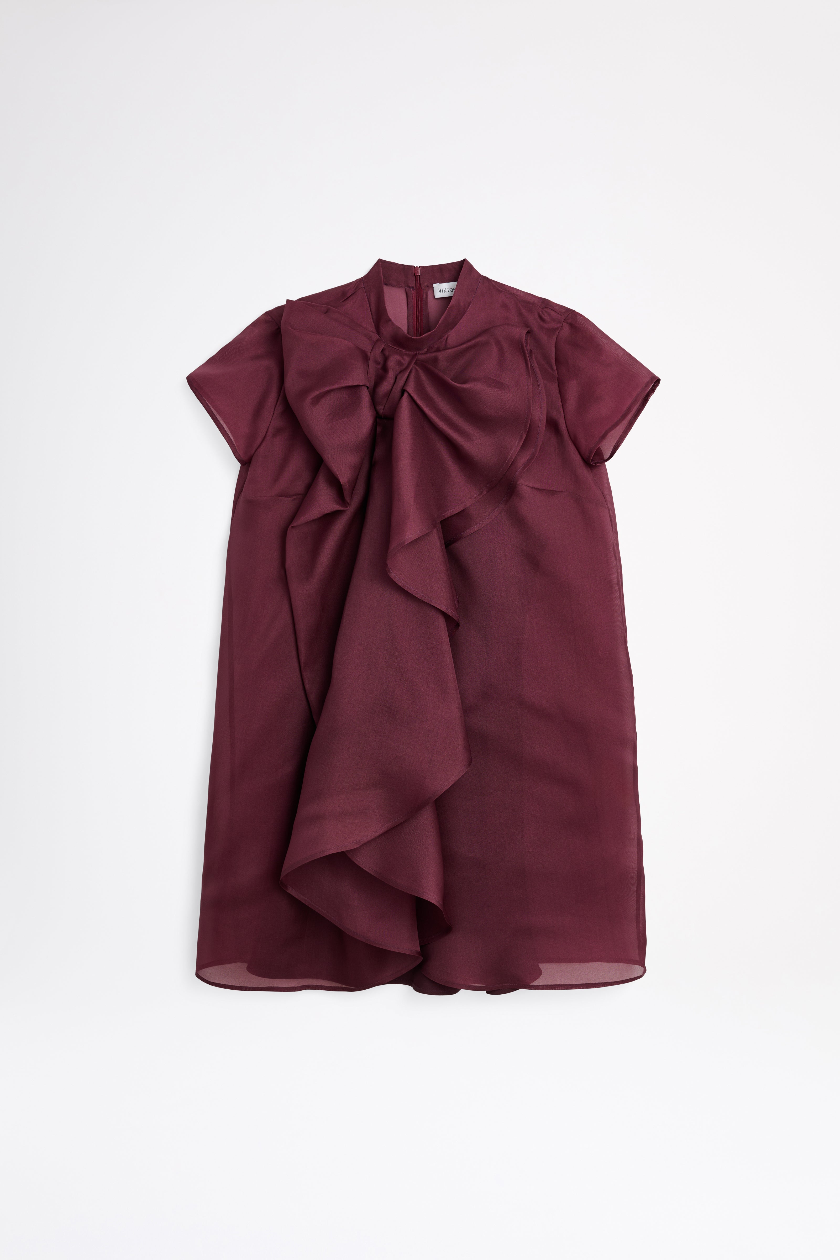 Maroon dress with ruffled details on a white background