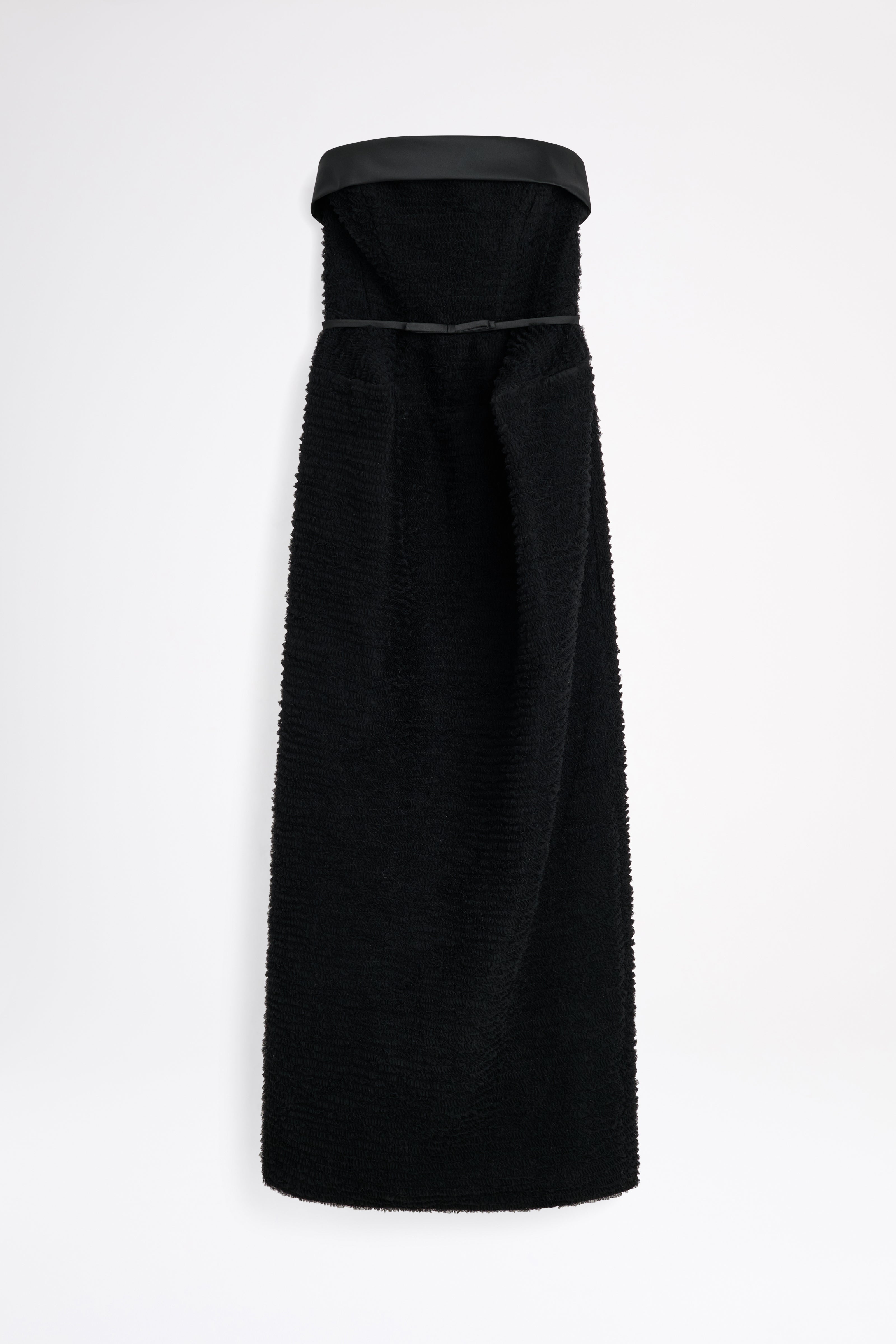 Black strapless dress with a fitted bodice on a white background