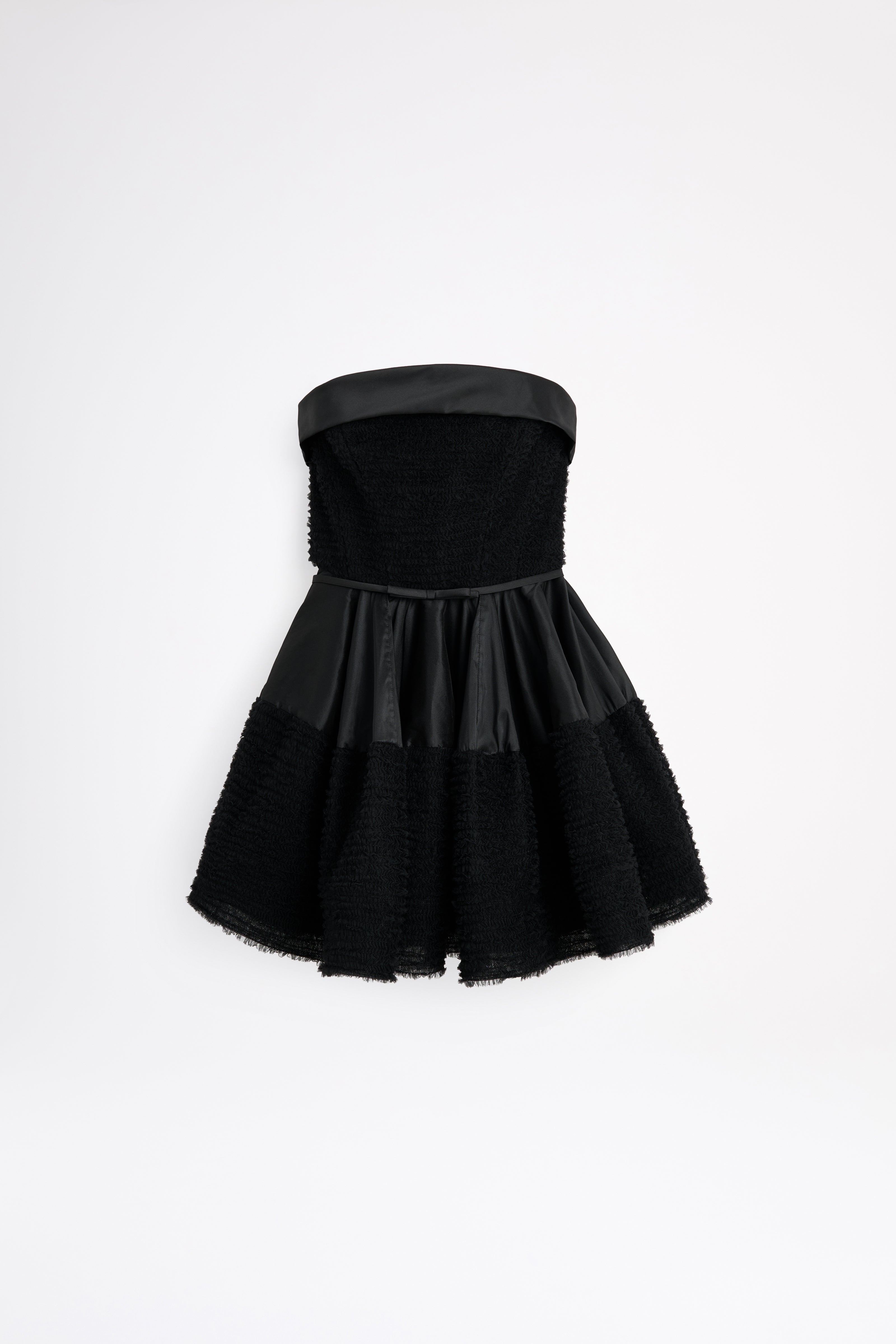 Black strapless dress with a textured skirt on a white background