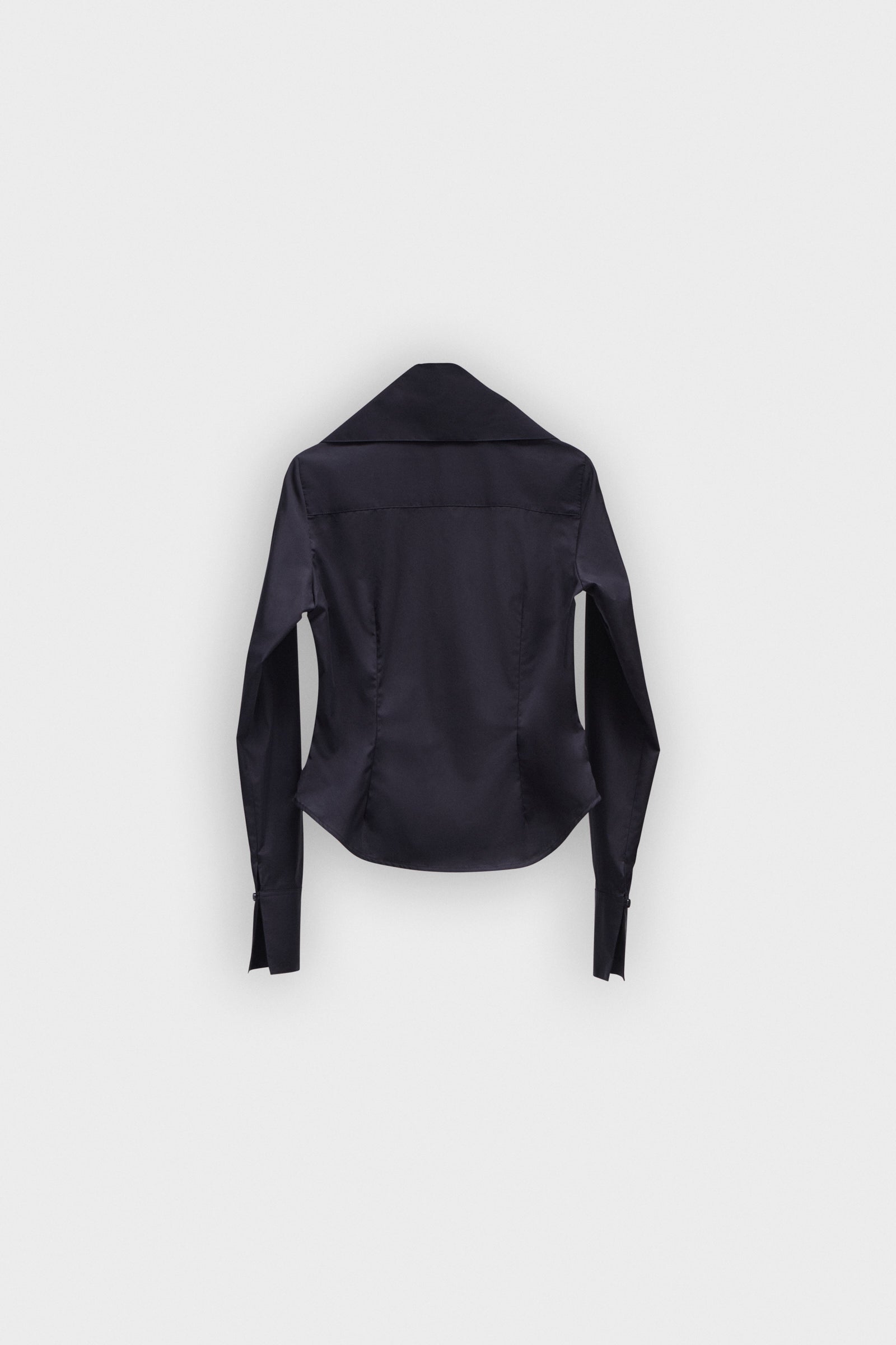 A black long sleeve shirt with a bow on the collar on a white background.