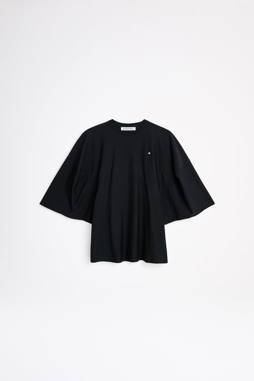 Black t-shirt with a small yellow label on a white background