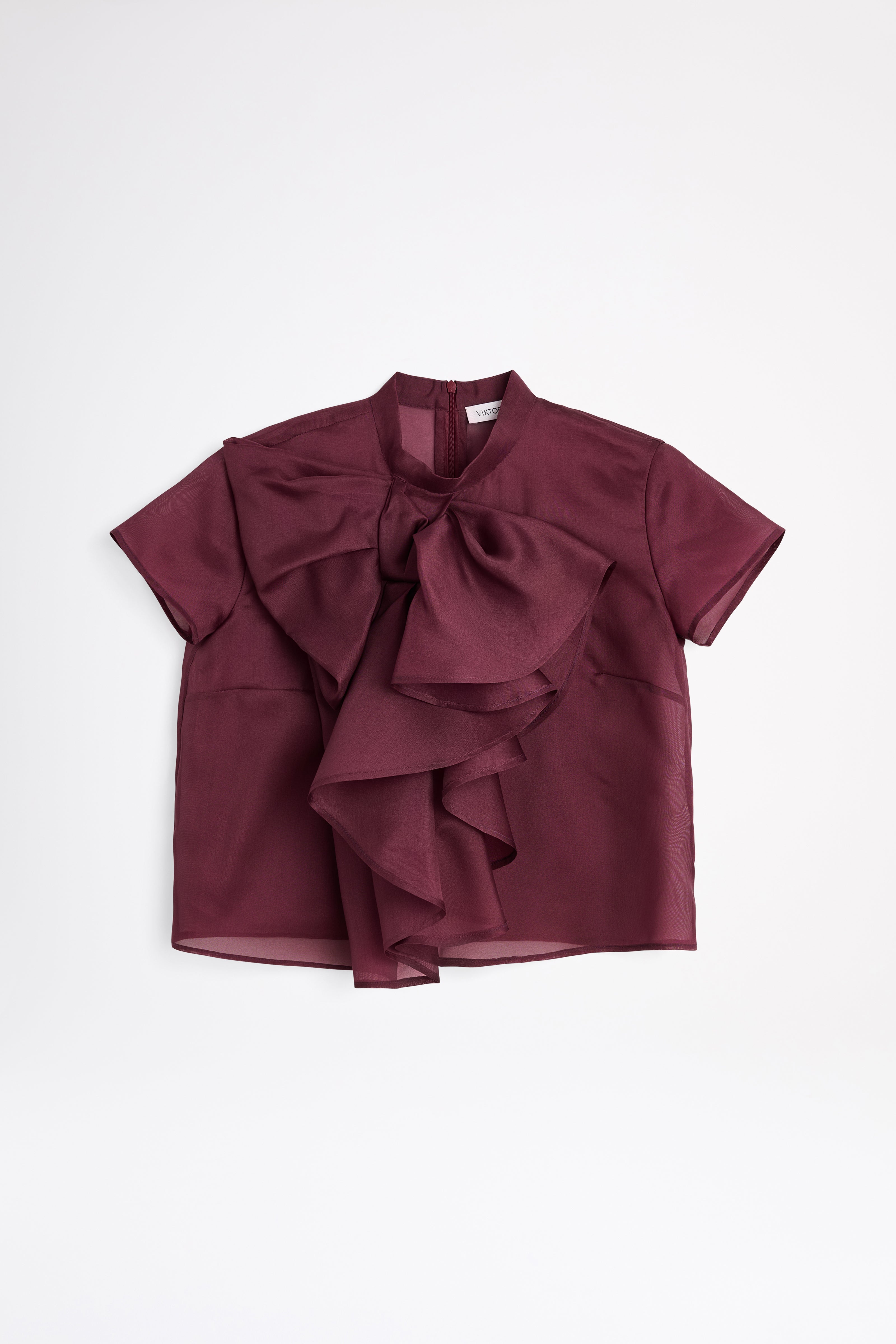 Maroon blouse with ruffled details on a white background