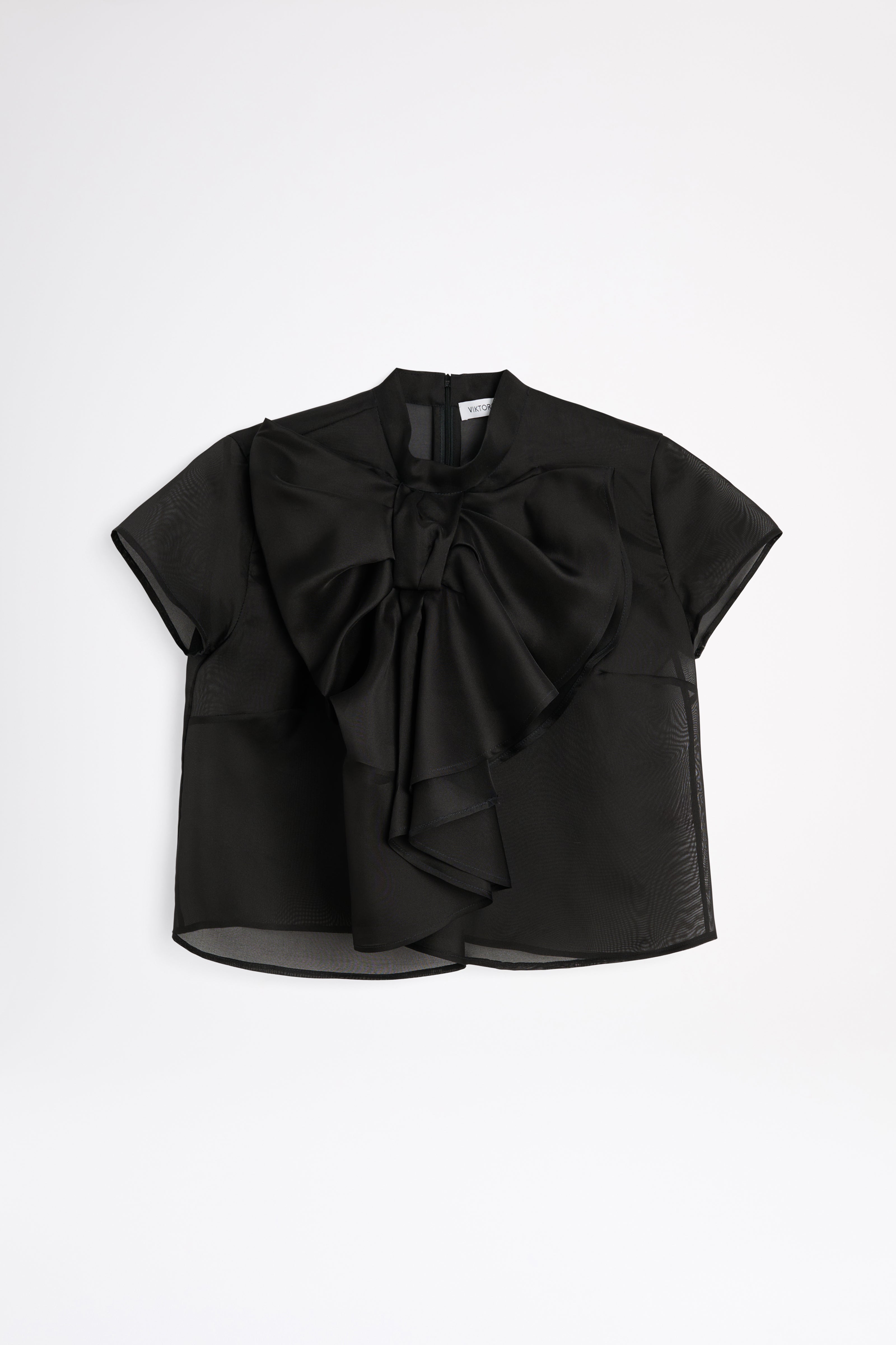 Black blouse with a large bow on a white background