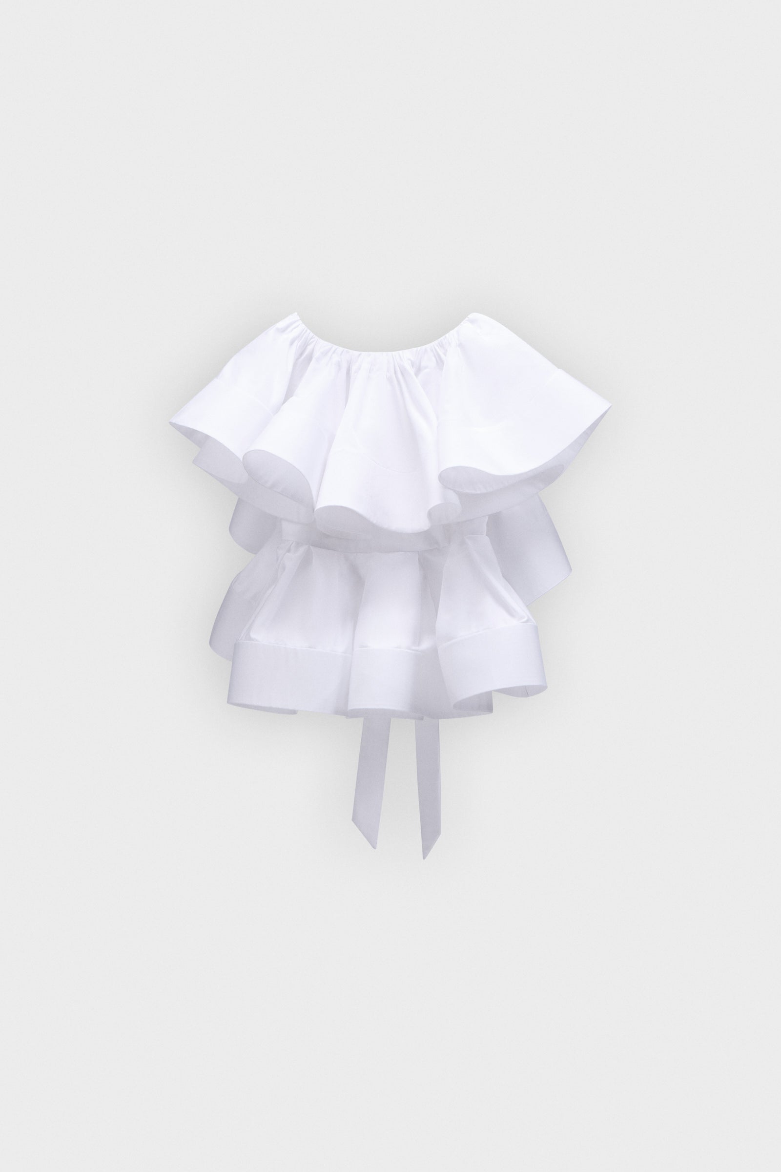 White ruffled blouse on a light gray background