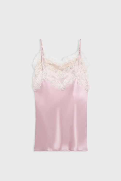 A light pink satin camisole slip with white lace trim along the neckline and thin spaghetti straps, shown flat against a light gray background.