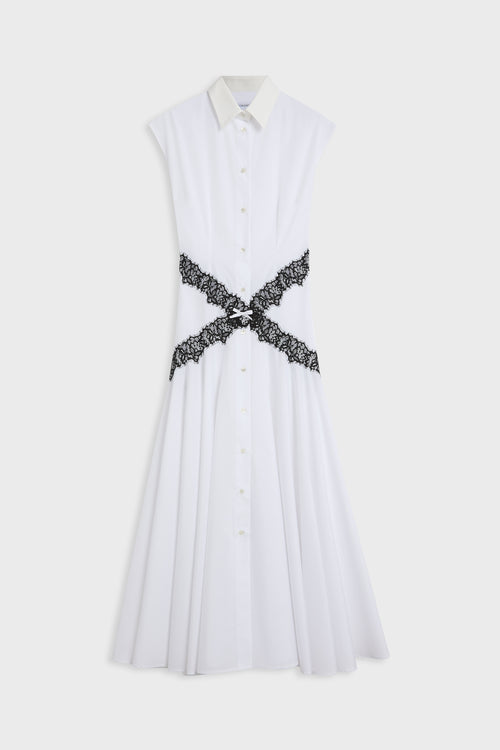 A white sleeveless collared shirt dress with a button-front bodice and a black lace cross-belt detail at the waist, shown against a light gray background.