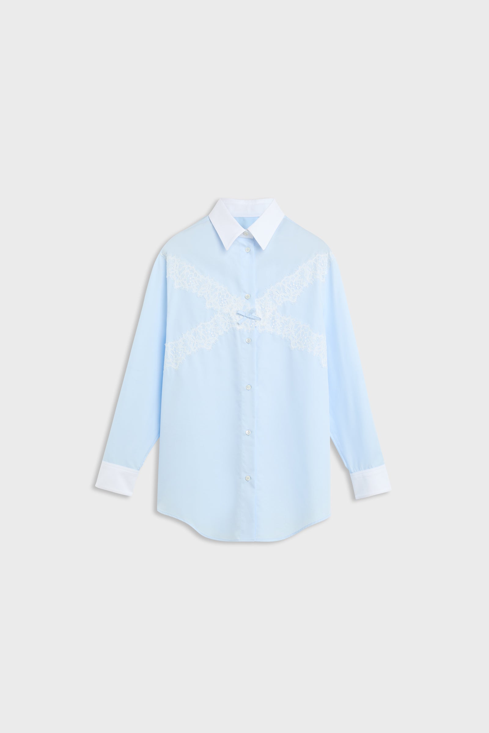 A light blue long-sleeve button-up shirt with a white collar, white cuffs, and white embroidered lettering across the chest, displayed on a light gray background.