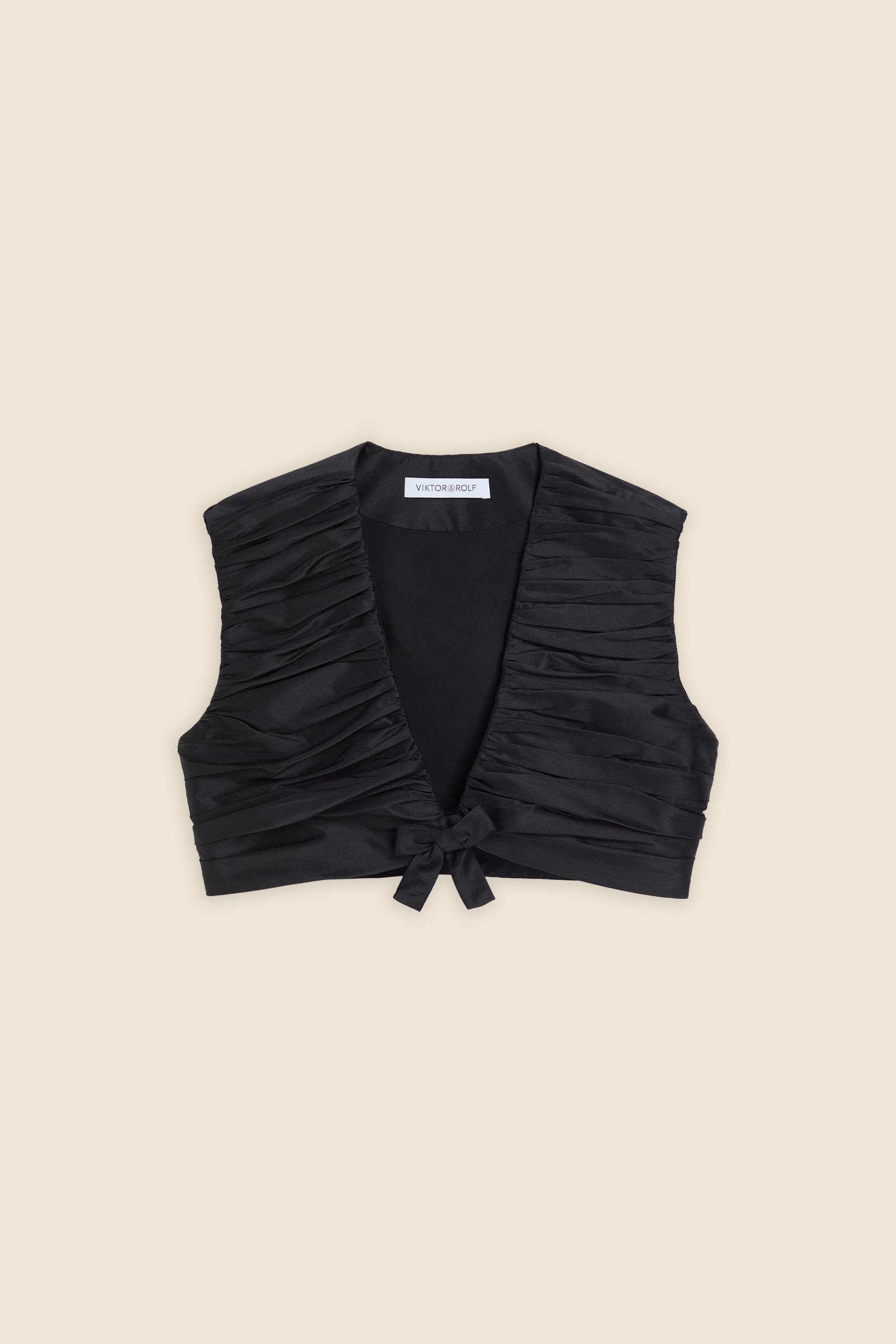 The meticulously placed pleats and silk-blend taffeta define the elegance of the top, reflecting classic haute couture craftsmanship with a modern edge