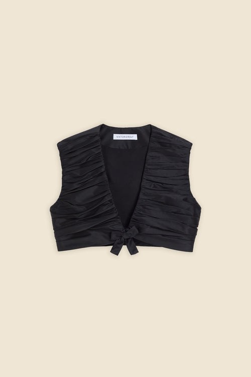 The meticulously placed pleats and silk-blend taffeta define the elegance of the top, reflecting classic haute couture craftsmanship with a modern edge