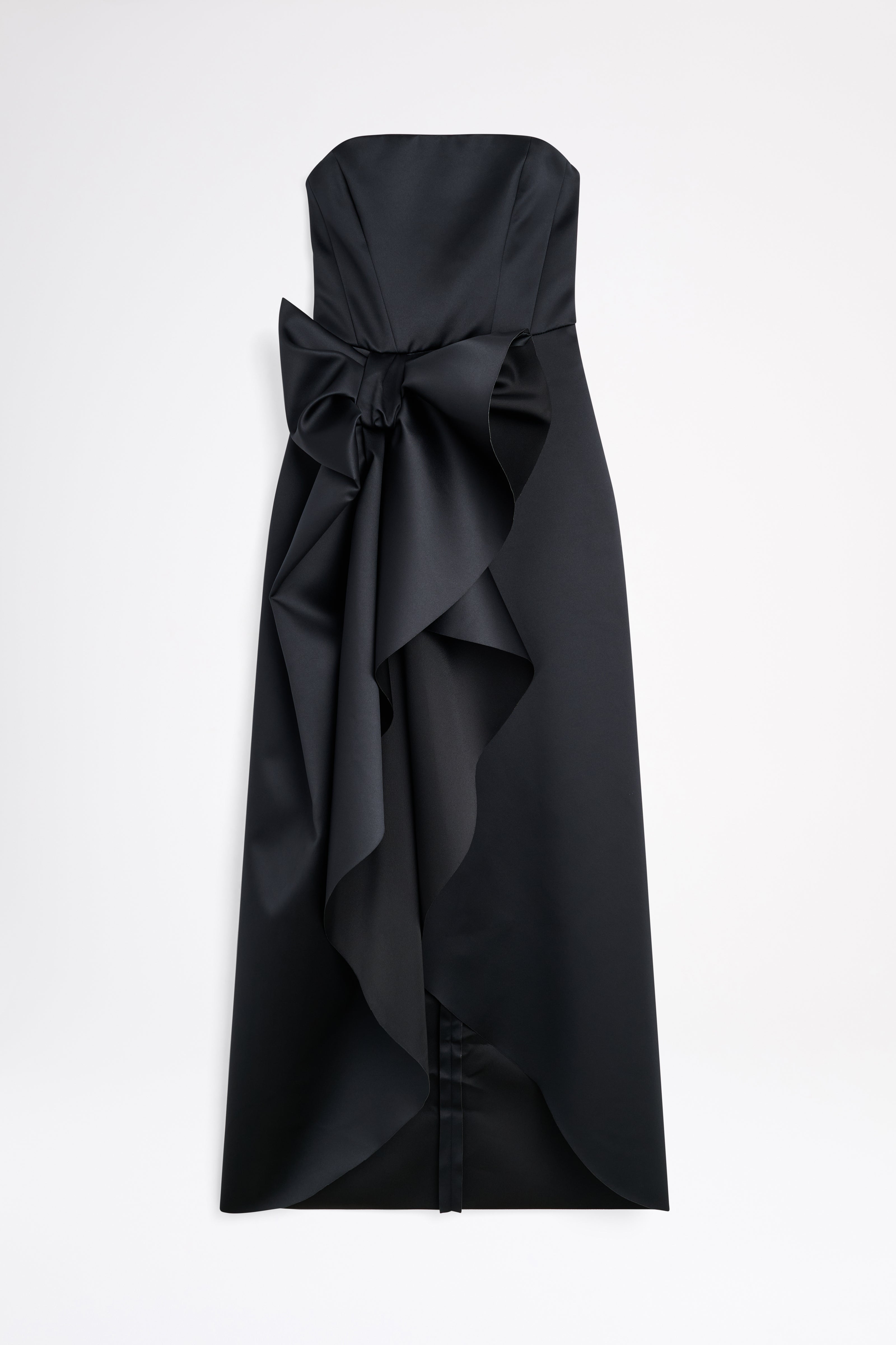 A satin black gown with a bow on a white background.