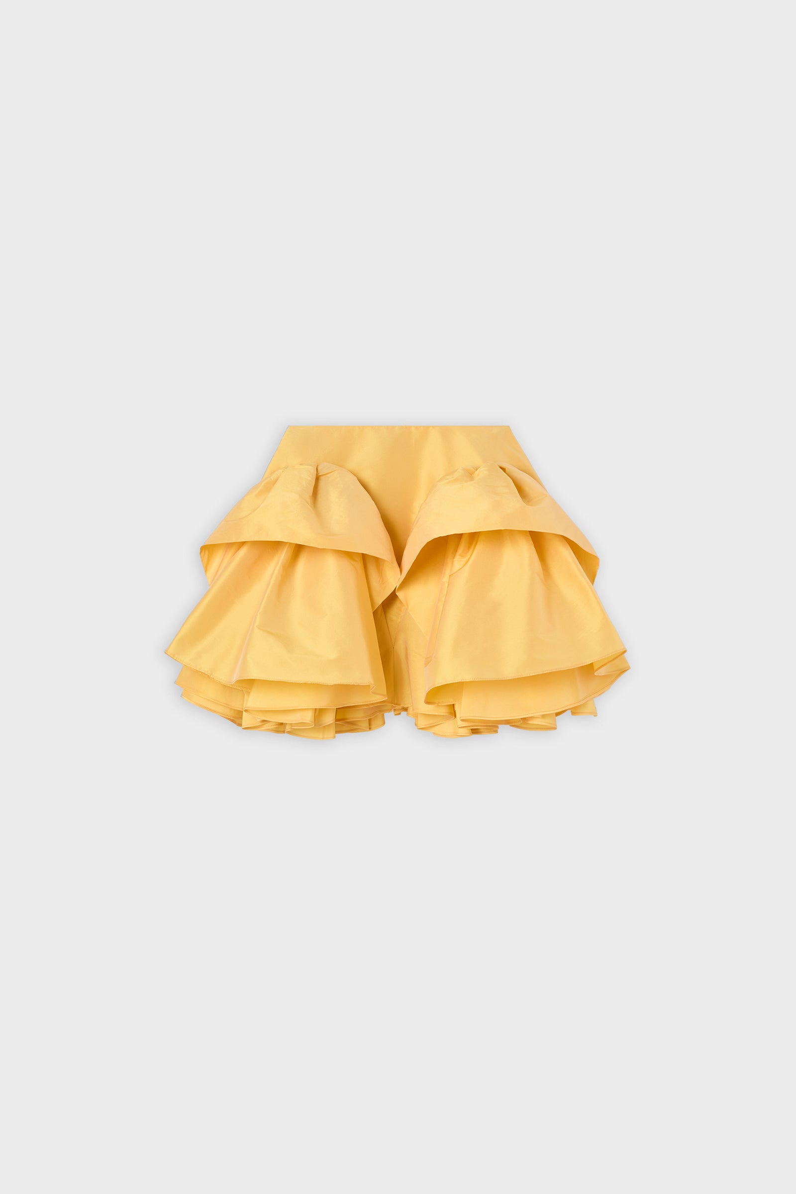 A yellow ruffled skirt on a white background.