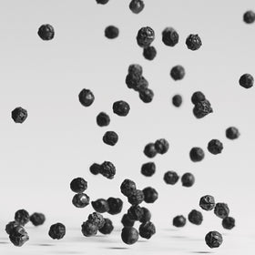 Black pepper close up while falling.