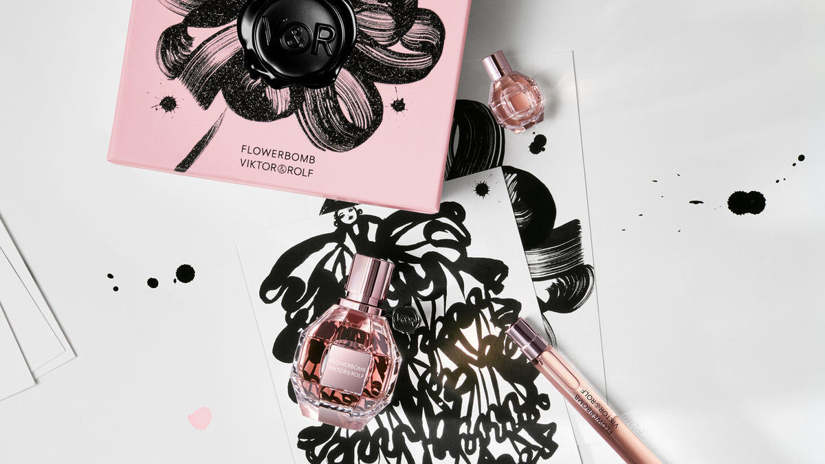 Viktor & Rolf Flowerbomb perfume bottle and packaging on a white background with black and pink accents.