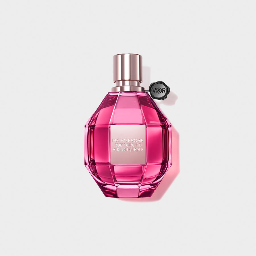 Pink Flowerbomb perfume on a white background.