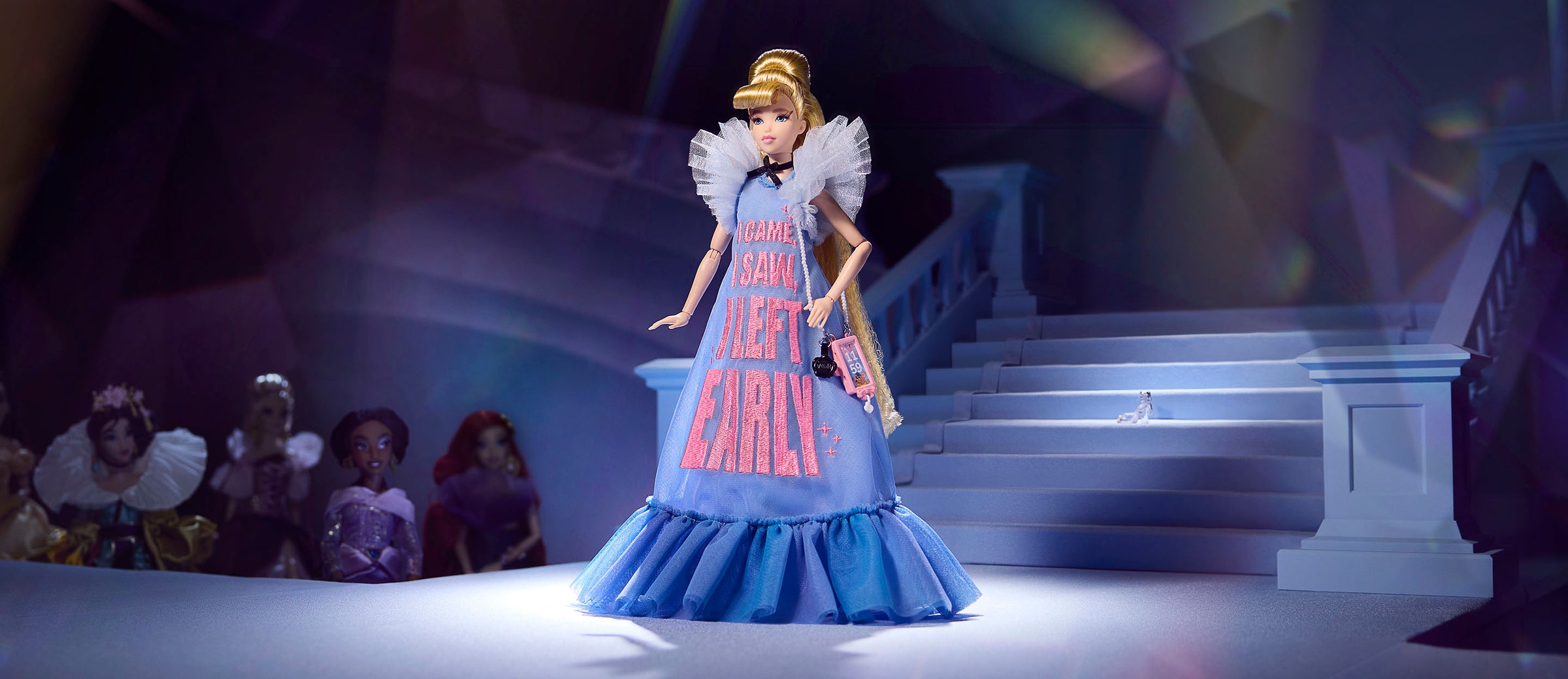 Cinderella doll wearing a long blue tulle dress standing on a runway.