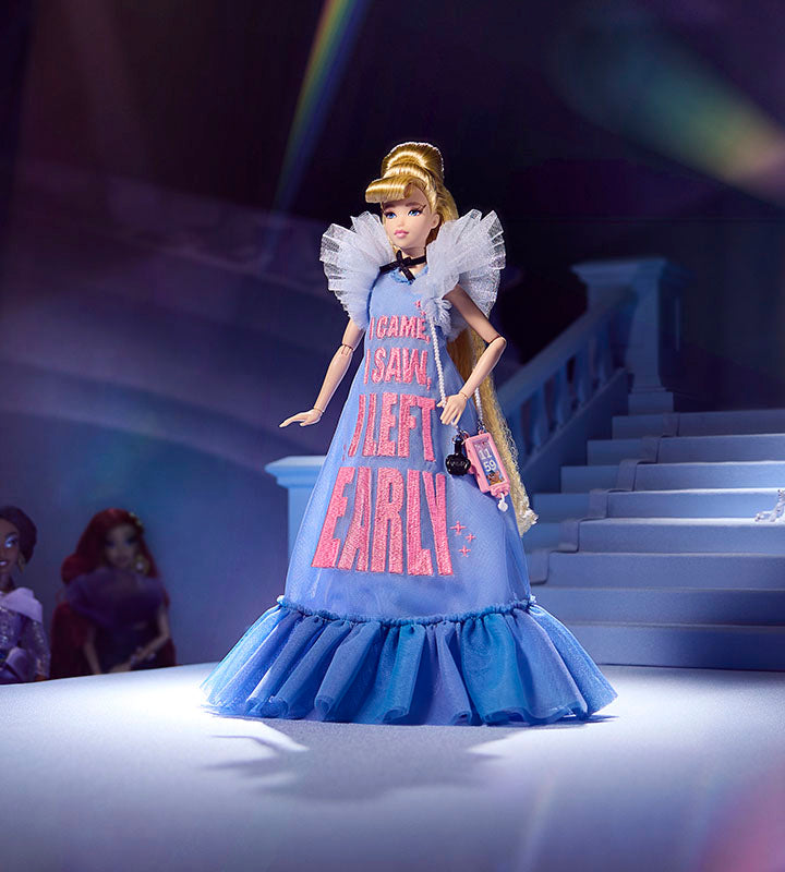 Cinderella doll wearing a long blue tulle dress standing on a runway.