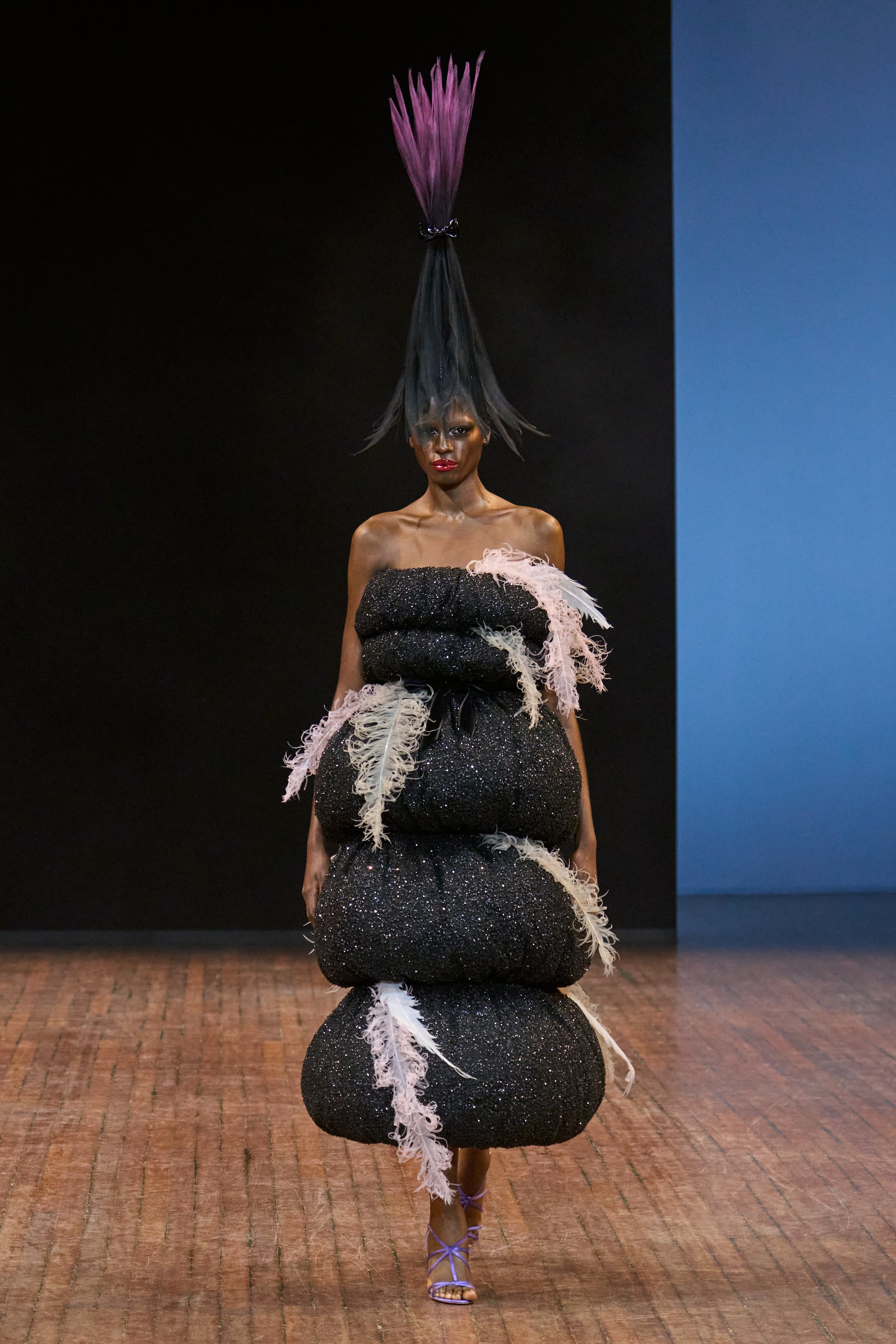 Viktor&Rolf Haute Couture Angry Birds show Autumn/Winter 2025, displaying one of the looks. The model is wearing a feather featured gown.
