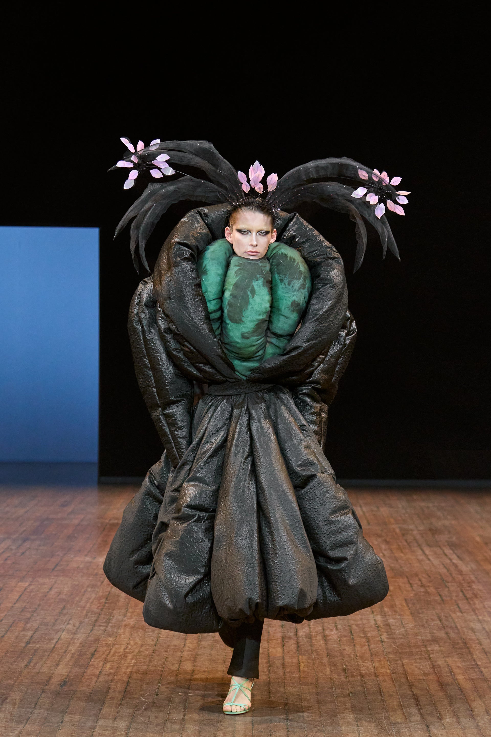 Viktor&Rolf Haute Couture Angry Birds show Autumn/Winter 2025, displaying one of the looks. The model is wearing a feather featured gown.