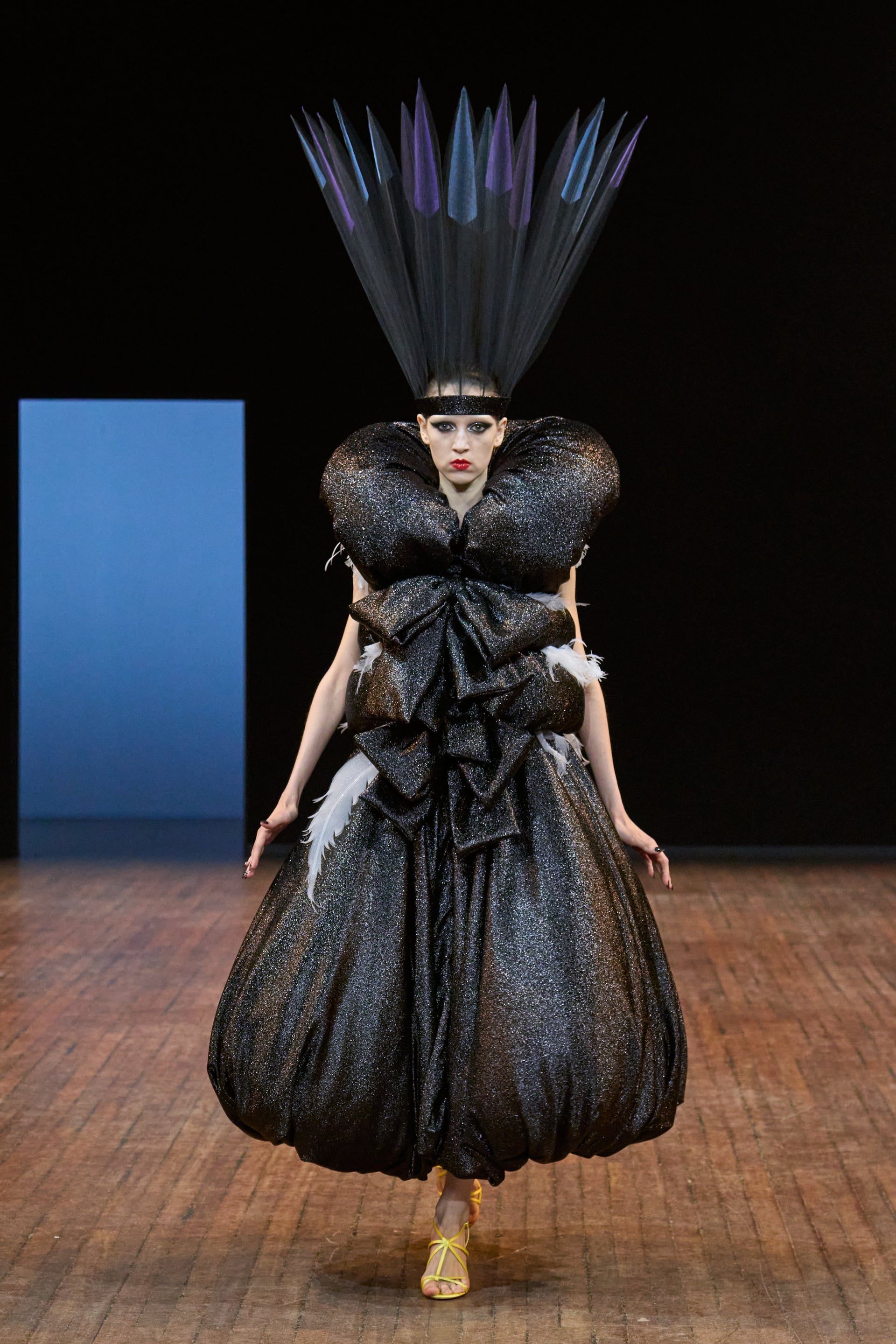 Viktor&Rolf Haute Couture Angry Birds show Autumn/Winter 2025, displaying one of the looks. The model is wearing a feather featured gown.