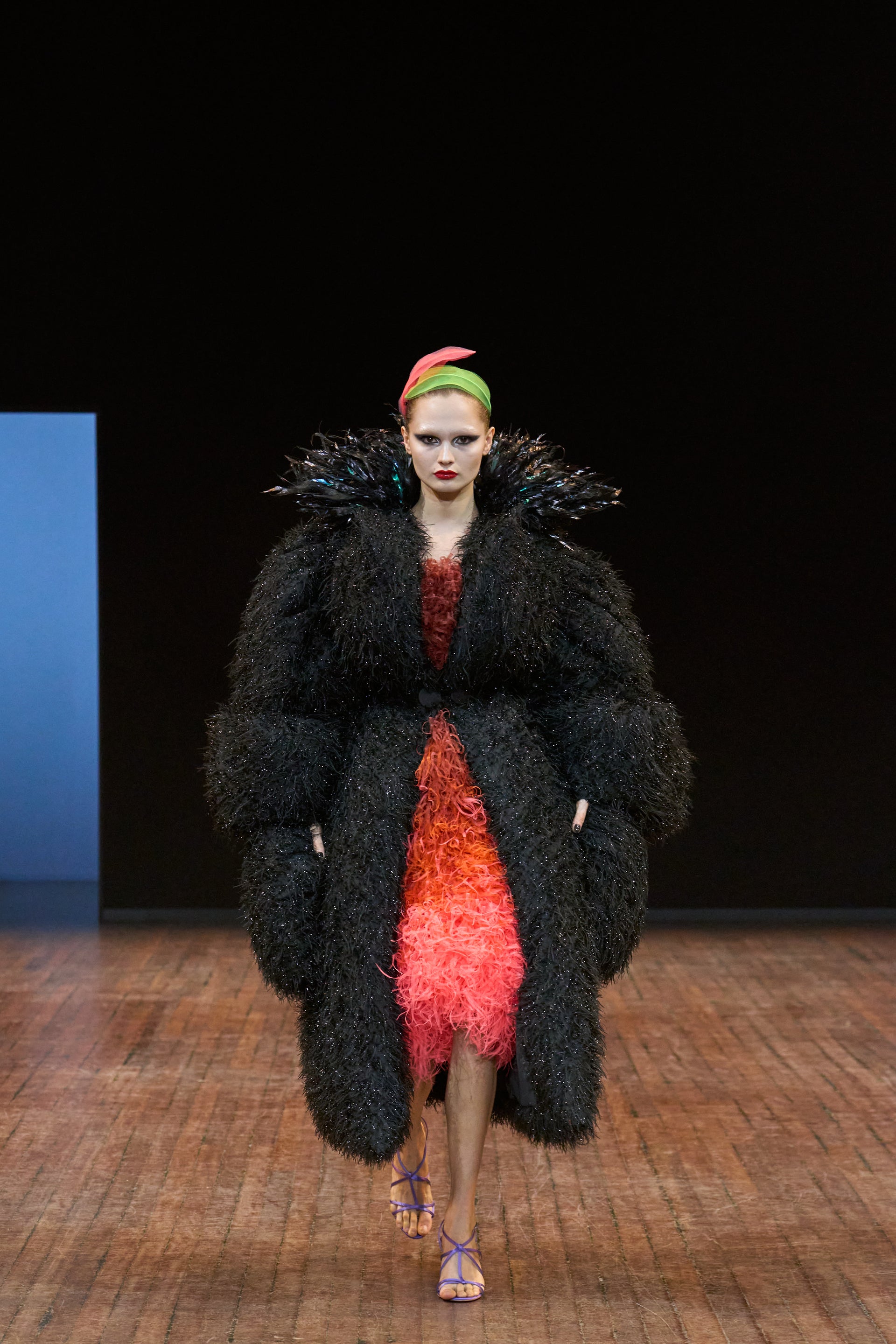 Viktor&Rolf Haute Couture Angry Birds show Autumn/Winter 2025, displaying one of the looks. The model is wearing a feather featured gown.