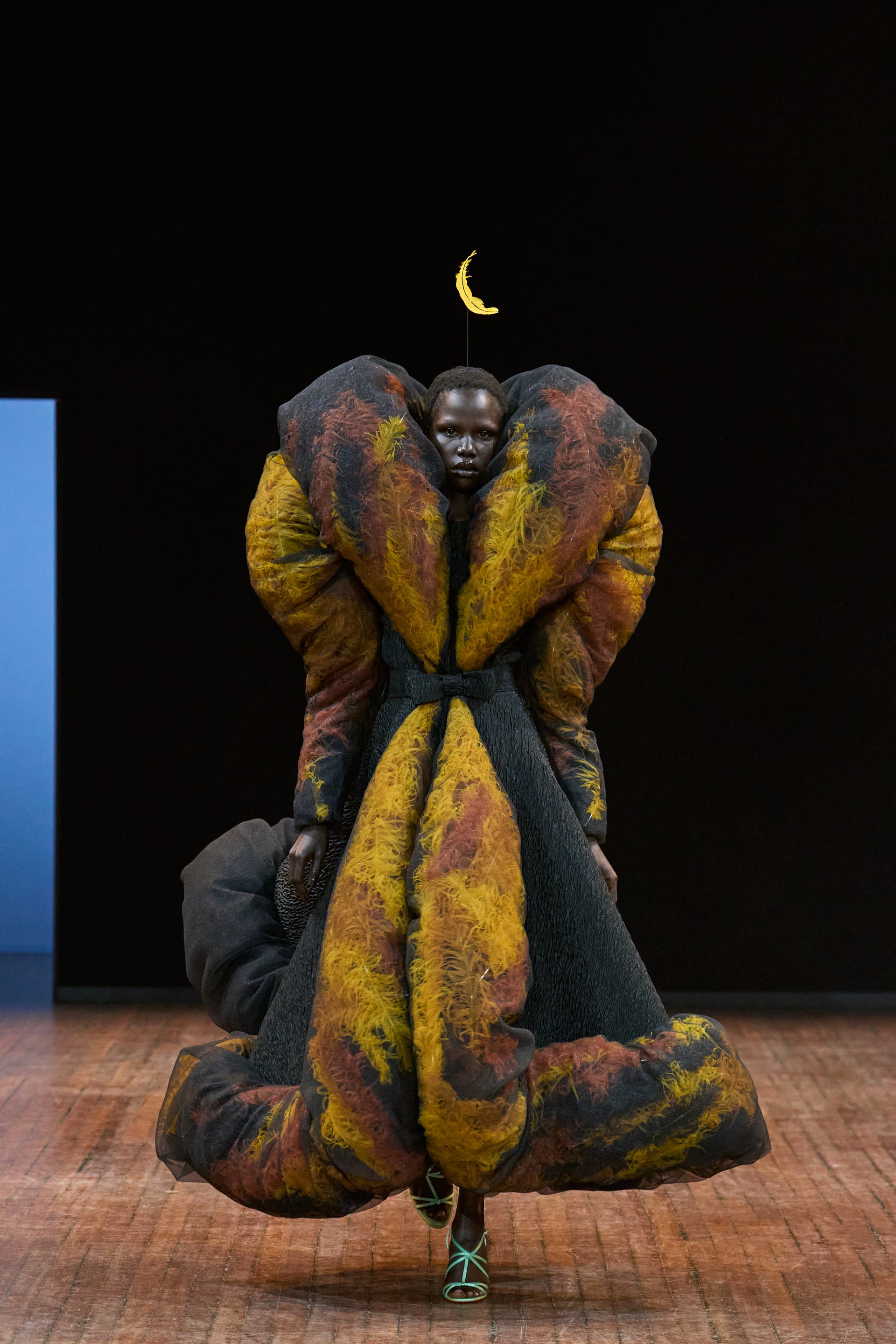 Viktor&Rolf Haute Couture Angry Birds show Autumn/Winter 2025, displaying one of the looks. The model is wearing a feather featured gown.