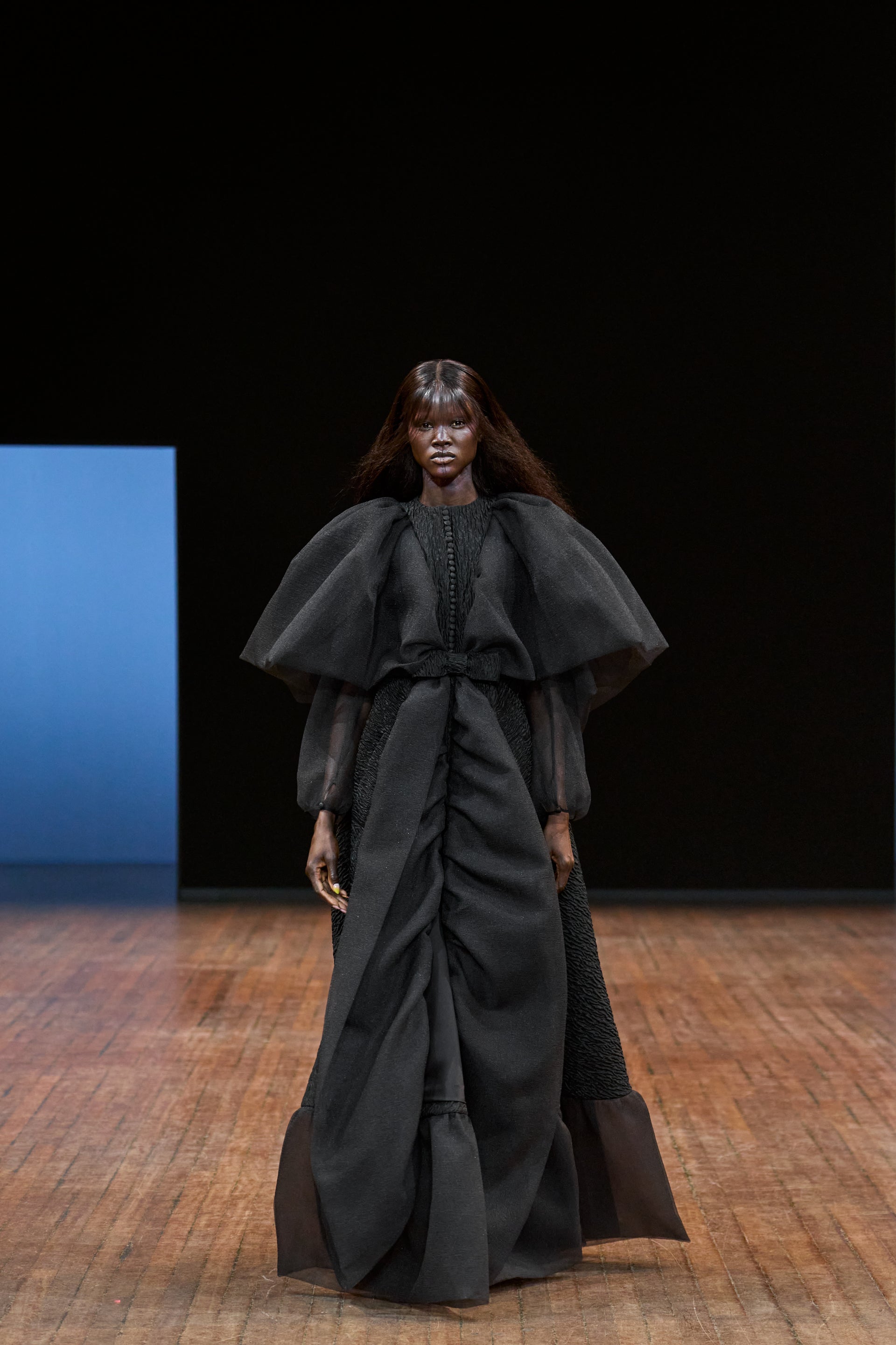 Viktor&Rolf Haute Couture Angry Birds show Autumn/Winter 2025, displaying one of the looks. The model is wearing a feather featured gown.