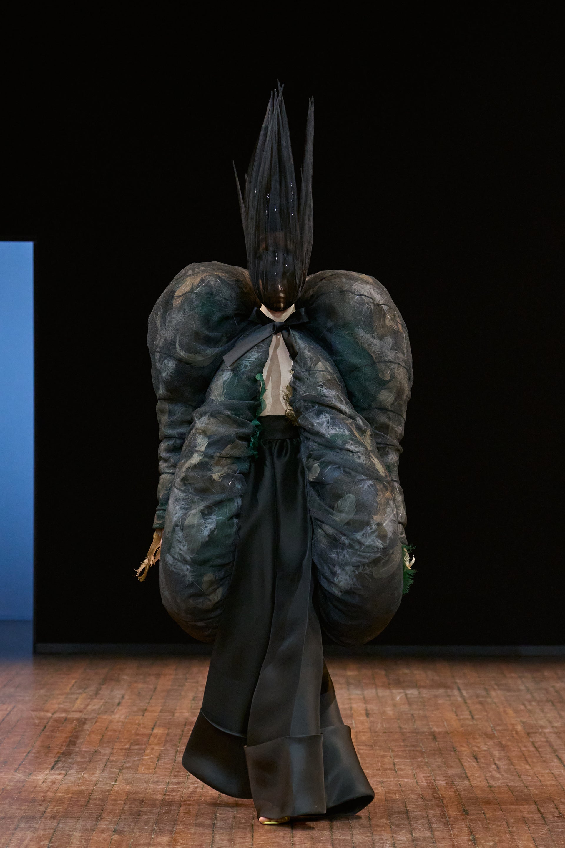Viktor&Rolf Haute Couture Angry Birds show Autumn/Winter 2025, displaying one of the looks. The model is wearing a feather featured gown.