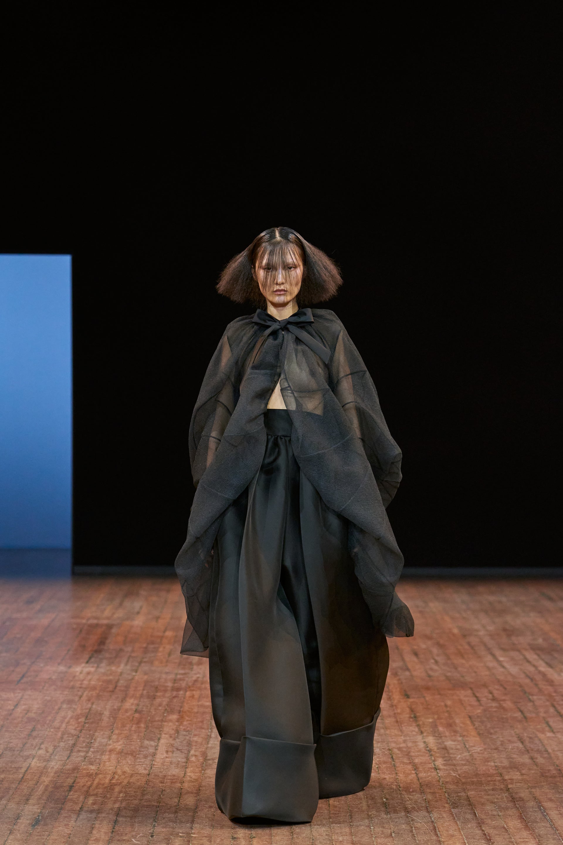Viktor&Rolf Haute Couture Angry Birds show Autumn/Winter 2025, displaying one of the looks. The model is wearing a feather featured gown.