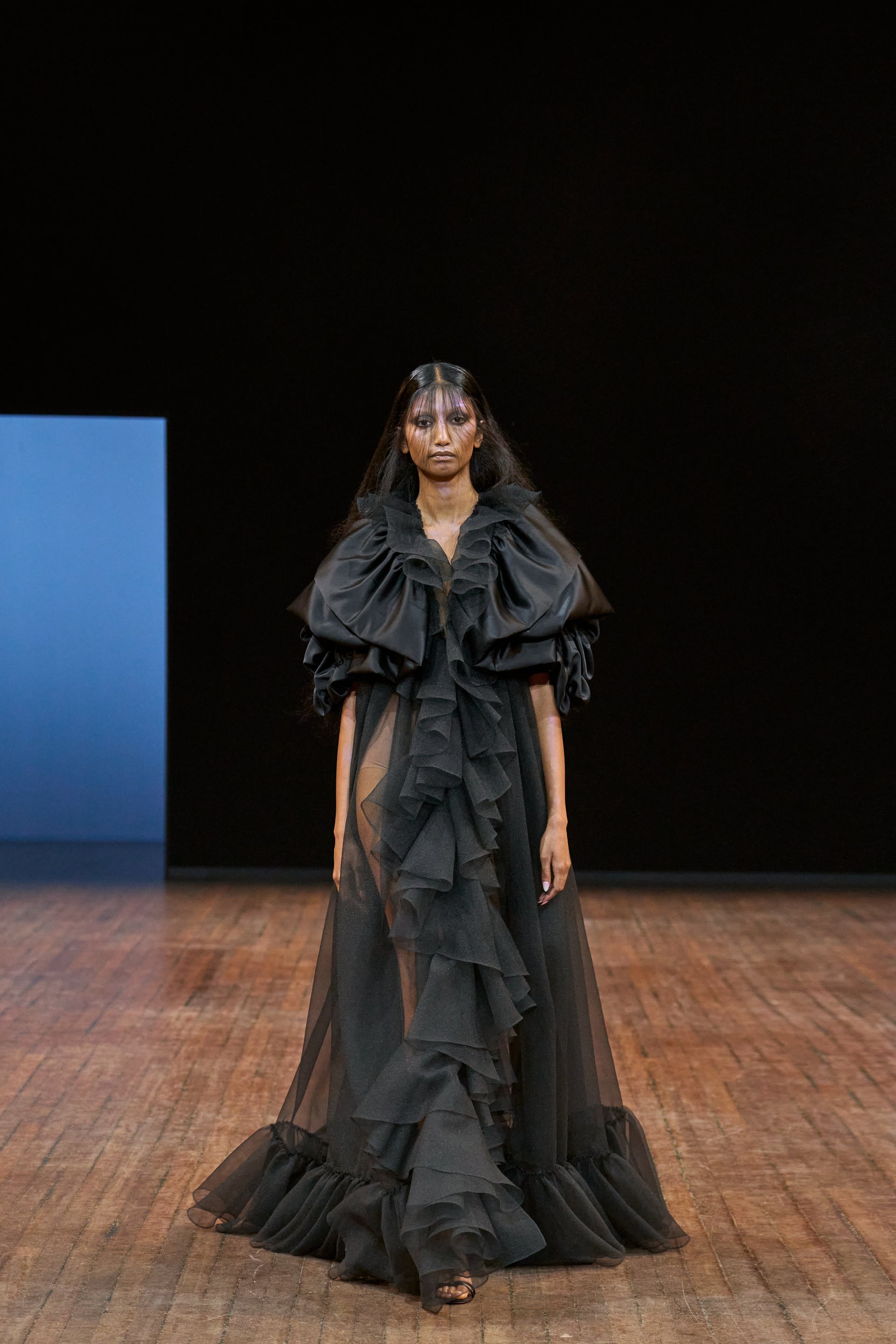 Viktor&Rolf Haute Couture Angry Birds show Autumn/Winter 2025, displaying one of the looks. The model is wearing a feather featured gown.