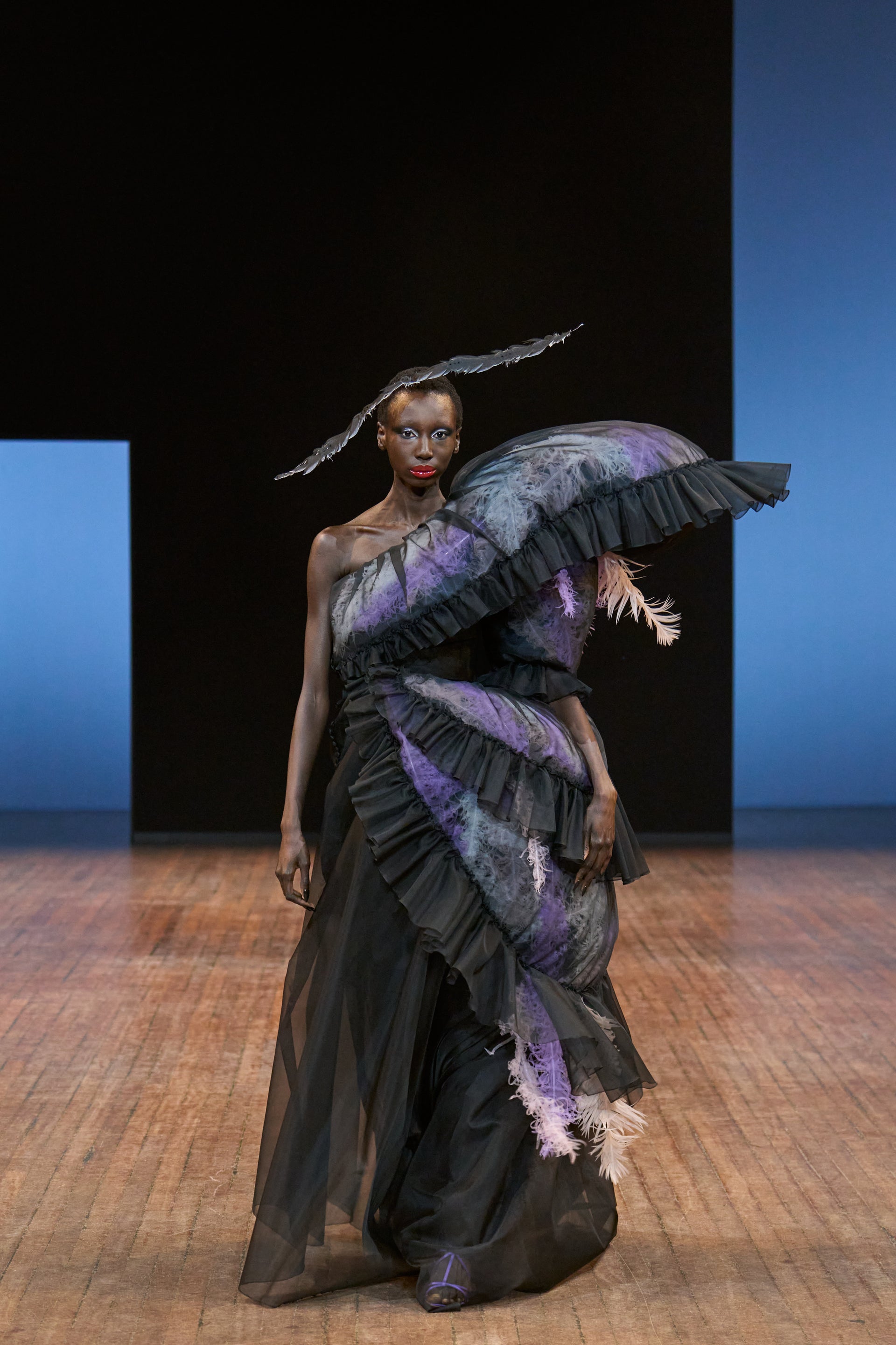 Viktor&Rolf Haute Couture Angry Birds show Autumn/Winter 2025, displaying one of the looks. The model is wearing a feather featured gown.