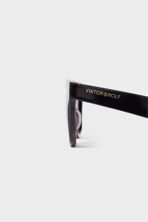 Sunglasses with 'Viktor & Rolf' branding on a white background
