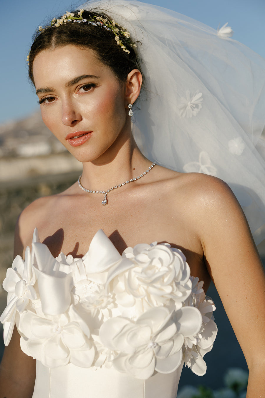 Bride holding a white bouquet with a scenic background