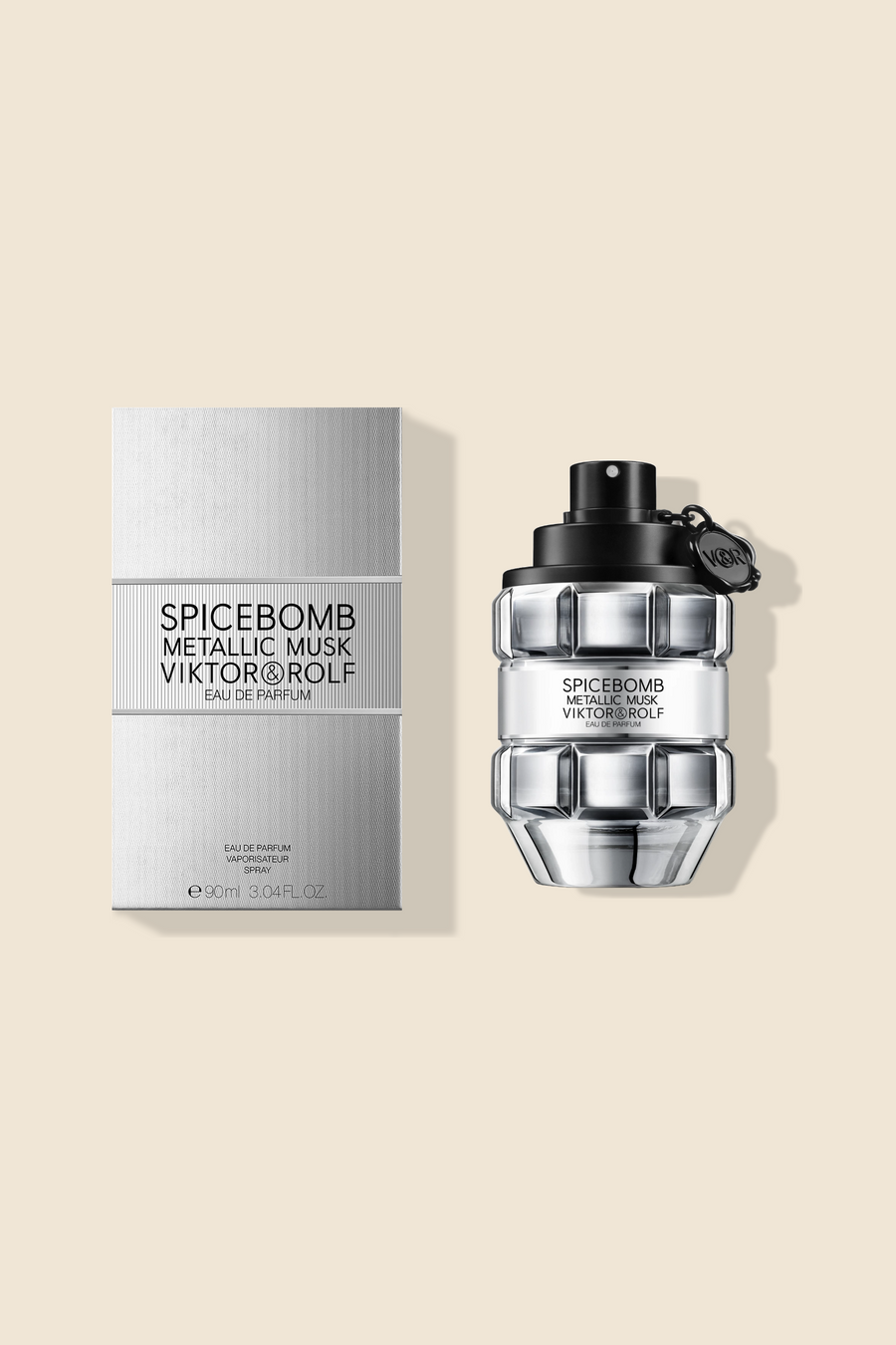 Metallic Musk perfume bottle in silver metal color next to its box on a beige background.