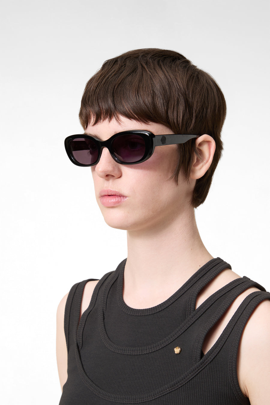 Model wearing stylish sunglasses with glossy black acetate frame.