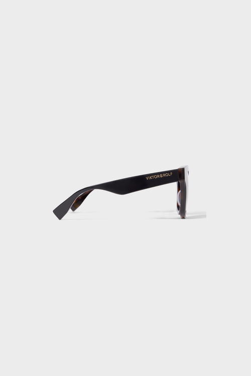 Sleek tortoiseshell sunglasses with oversized frames and gradient brown lenses, perfect for a chic and stylish look. Shown from the side.