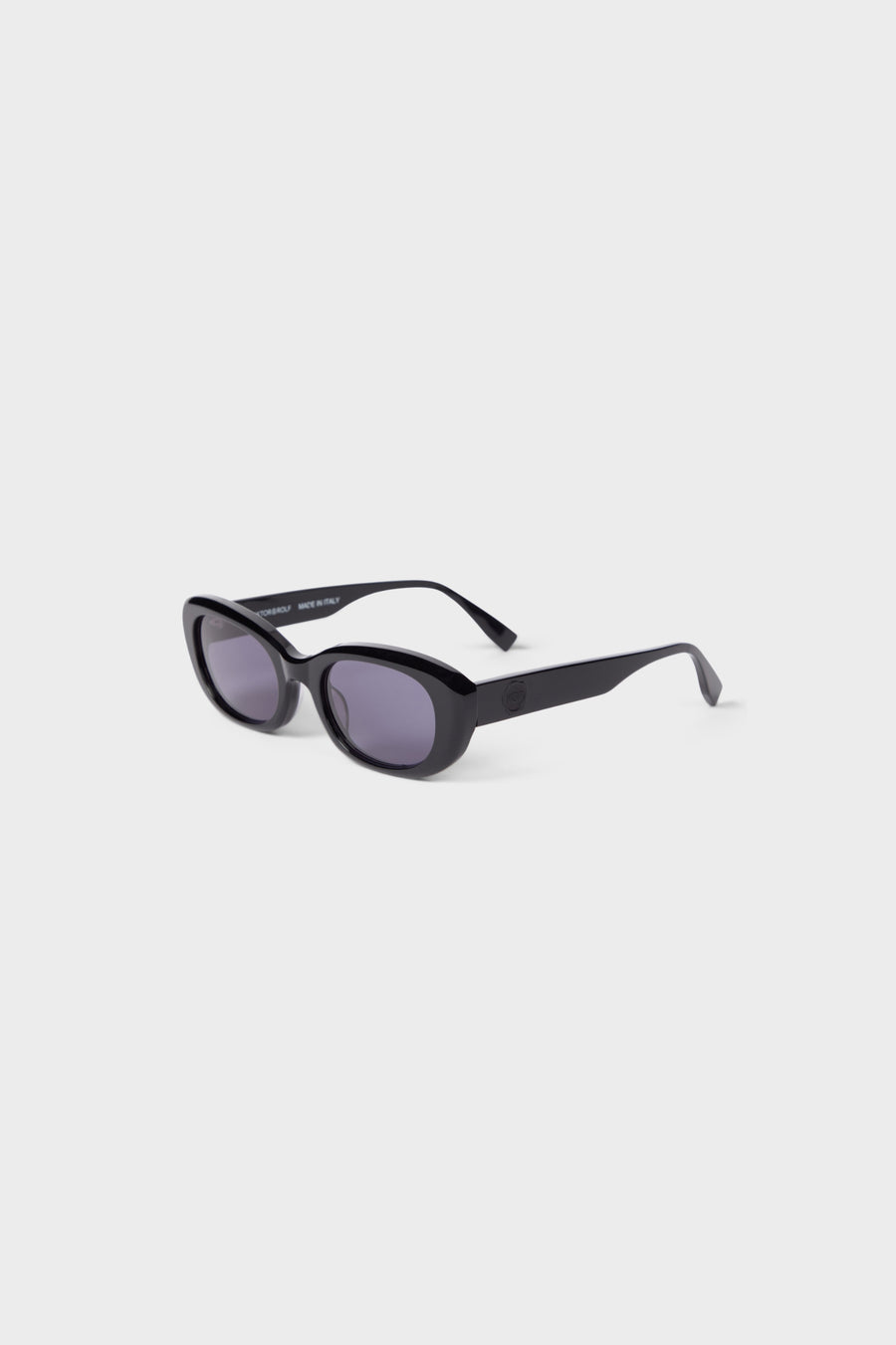 Chic black oval sunglasses with sleek acetate frame and dark lenses, exuding a modern and sophisticated look.