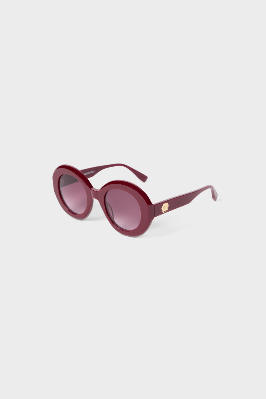Burgundy round glasses on a white background.