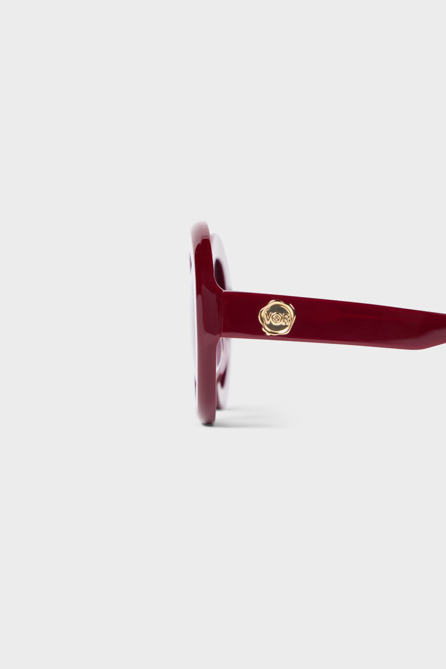 Burgundy round glasses close up.