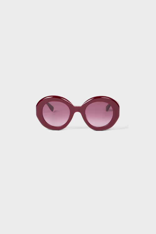 Burgundy round glasses on a white background.
