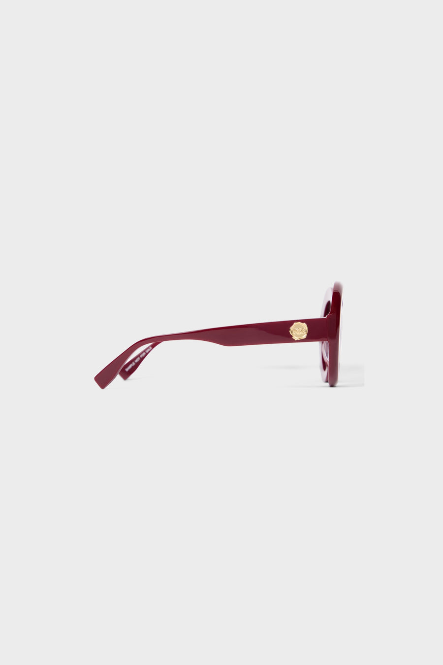 Burgundy round glasses on a white background.