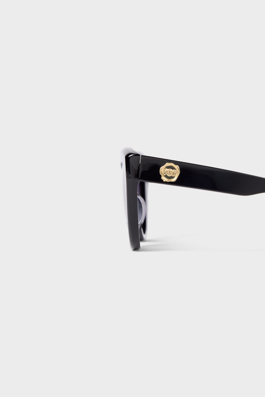 Close up on black cat-eye sunglasses on a white background.