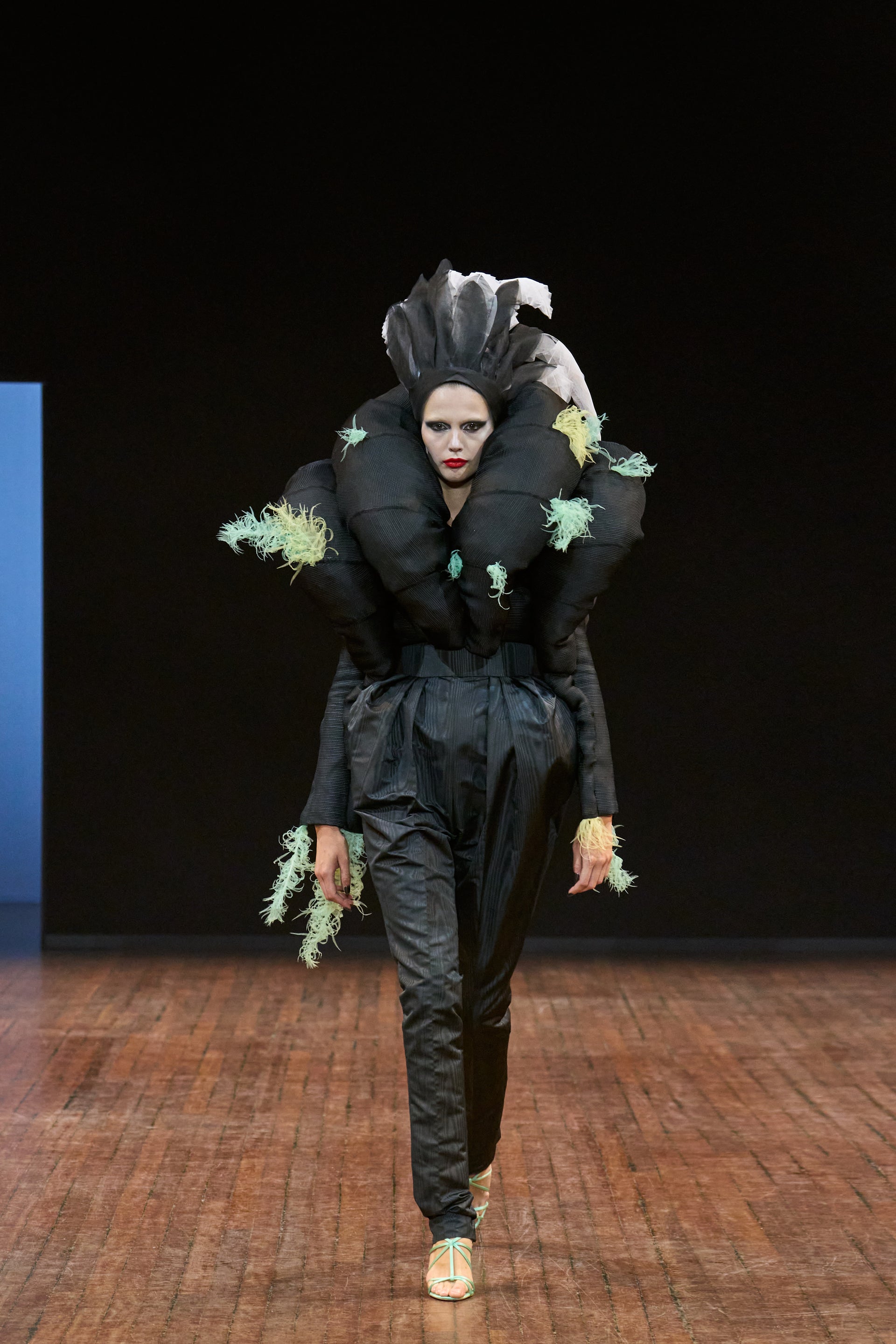 Viktor&Rolf Haute Couture Angry Birds show Autumn/Winter 2025, displaying one of the looks. The model is wearing a feather featured gown.