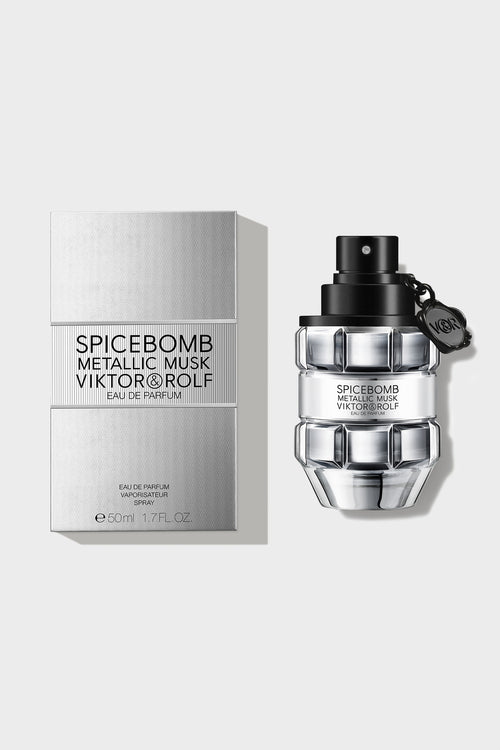 Elegant grenade-shaped fragrance bottle with a matte black finish and clear glass accents, designed by a luxury brand.