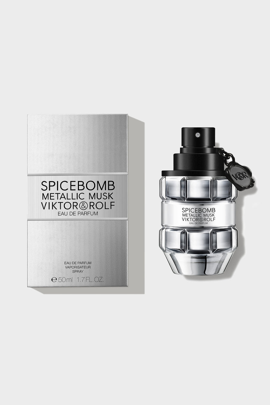Elegant grenade-shaped fragrance bottle with a matte black finish and clear glass accents, designed by a luxury brand.