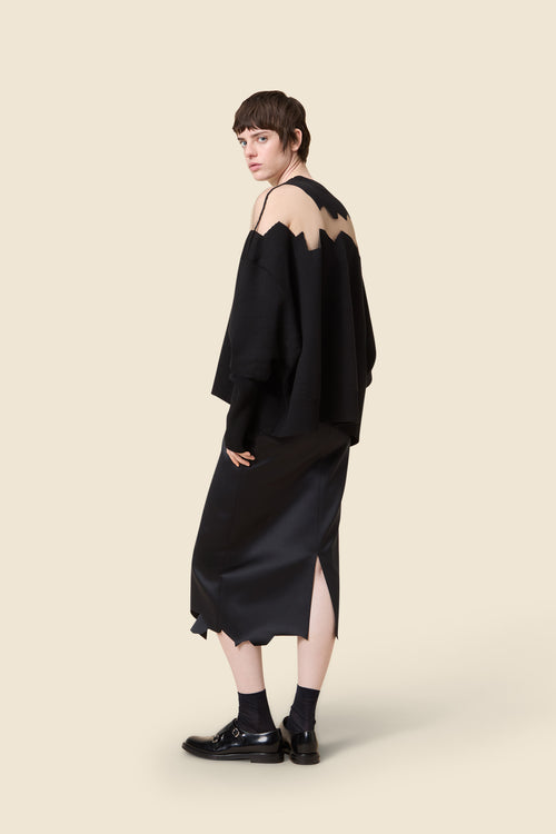 The knitwear, inspired by viktor&rolf's scissorhands, is crafted with 100% merino wool and showcases intricate holes knitted with transparent yarn in a jacquard technique