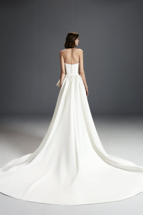 Viktor & Rolf Mariage Bridalwear Collection's Strapless Dreamy Bow Gown, elegant design with flowing white train.